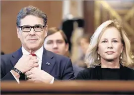  ?? Carolyn Kaster Associated Press ?? RICK PERRY, with wife Anita in Washington, told a Senate committee that he accepts that “man-made activity” is at least partly responsibl­e for climate change.