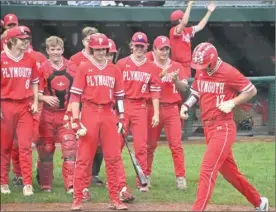  ?? PILOT PHOTO/KATHY HALL ?? Michael Sheely is greeted at the plate by his teammates after blasting a solo home run for the Pilgrims.