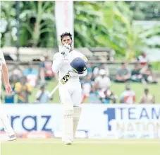  ??  ?? Sri Lanka's cricketer Dhananjaya de Silva celebrates after scoring a century (100 runs) during the third day of the final cricket Test match between Sri Lanka and New Zealand. - AFP photo