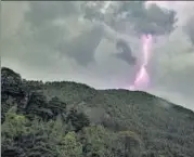  ?? AP ?? A bolt of lightning seen above a mountain of the Dhauladhar Range in Dharmsala on Thursday. The region saw heavy rains and thundersto­rms.