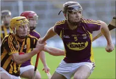  ??  ?? Wing-back Jack Kelly has his hand held by Kilkenny’s Richie Leahy.