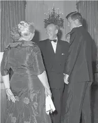  ?? BYRON ROLLINS / THE ASSOCIATED PRESS FILES ?? President John F. Kennedy and Lester Pearson, leader of Canada’s Liberal Party, talk before a Nobel Prize gala at the White House in the spring of 1962. Then-Canadian prime minister John Diefenbake­r was said to be enraged Pearson was invited instead of him.