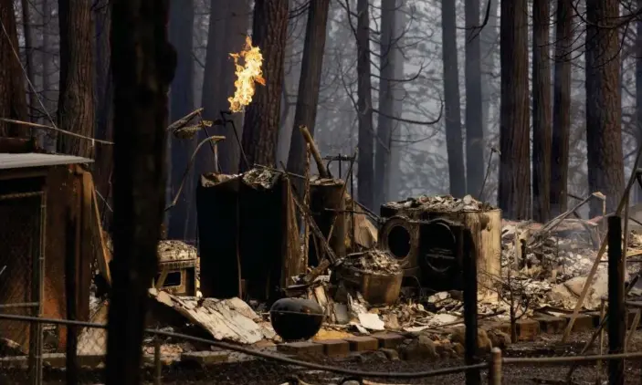  ?? Photograph: Peter DaSilva/UPI/Rex/Shuttersto­ck ?? A burned home is seen as live gas burns in the area of Grizzly Flats.