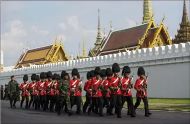  ?? ASSOCIATED PRESS ?? Thai Royal Guard march outside the Grand Palace Friday, prior to a religious ceremony for the late King Bhumibol Adulyadej in Bangkok, Thailand. Bhumibol, the world’s longest reigning monarch, died on Thursday at the age of 88.