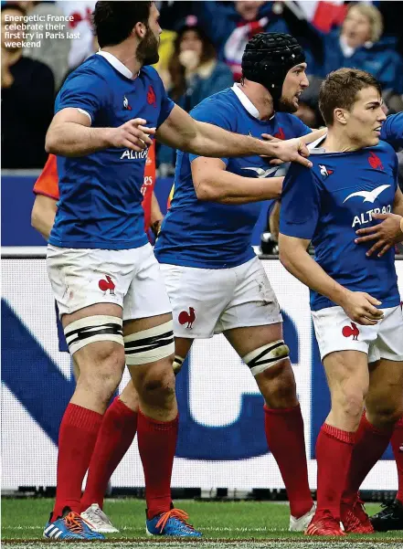  ??  ?? Energetic: France celebrate their first try in Paris last weekend