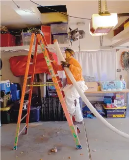  ?? ADOLPHE PIERRE-LOUIS/JOURNAL ?? Jose Castillo, an insulation installer for Garrity Insulation, works in a Northeast Heights home attic Feb. 11.