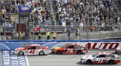  ?? ALEX GALLARDO — THE ASSOCIATED PRESS ?? Kyle Larson (42) leads Martin Truex Jr. (78) and Denny Hamlin (11) across the Sunday’s NASCAR Cup Series race at Auto Club Speedway in Fontana, Calif. finish line in final laps of