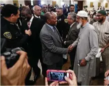  ?? Karen Warren / Houston Chronicle ?? Police Chief Art Acevedo and Mayor Sylvester Turner greet members of the Muslim community during a town hall meeting Monday in southwest Houston.