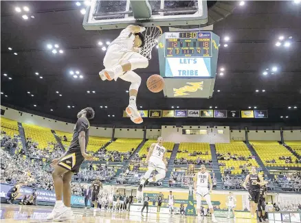  ?? MIKE CAUDILL/FREELANCE ?? William & Mary’s Tyler Hamilton makes some fans roar with a dunk in the first half of Saturday’s loss to Towson at Kaplan Arena.