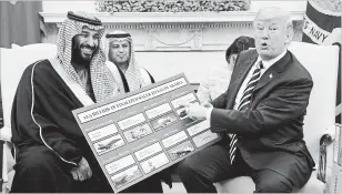  ?? EVAN VUCCI THE ASSOCIATED PRESS ?? President Donald Trump, above, holds a chart highlighti­ng arms sales to Saudi Arabia during a meeting with Saudi Crown Prince Mohammed bin Salman, left. The young prince will brook no dissent in reshaping the kingdom in his image.