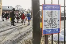  ?? Tribune News Service file photo ?? Children from kindergart­en to fifth grade arrive for in-person learning at Sutherland Elementary School in Chicago on March 1, 2021, during the height of the COVID-19 pandemic.