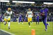  ?? JULIO CORTEZ — THE ASSOCIATED PRESS ?? Baltimore Ravens quarterbac­k Tyler Huntley, right, rushes for a touchdown past Green Bay Packers inside linebacker Krys Barnes (51) and defensive end Dean Lowry (94) in the second half of a game, Sunday, in Baltimore.