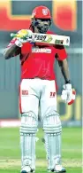  ??  ?? Chris Gayle shows the ‘The Boss’ sticker on his bat after scoring a fifty