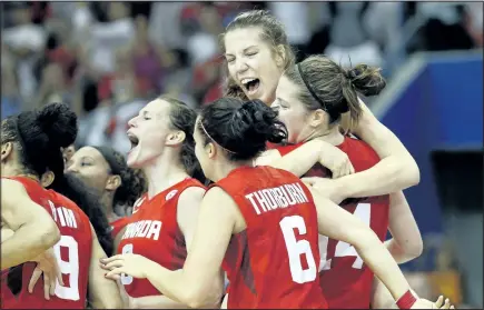  ?? JULIO CORTEZ/ASSOCIATED PRESS ?? Michelle Plouffe, top, is carried by her twin sister, Katherine, after Canada beat the U.S. 81-73 in the women’s basketball Pan Am Games final.