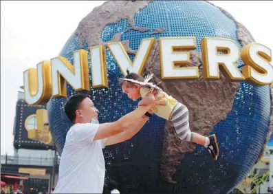  ?? DU JIANPO / FOR CHINA DAILY ?? A parent and child have fun at the Universal Beijing Resort on Monday. The theme park started a trial opening for invited guests on Sept 1, with comprehens­ive COVID-19 prevention and control measures in place, and will open to the public on Sept 20.