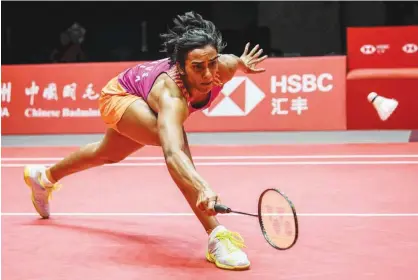  ?? Agence France-presse ?? India’s PV Sindhu hits a return against Zhang Beiwen of the US during their women’s singles third round match at the 2018 BWF World Tour Finals in Guangzhou on Friday.