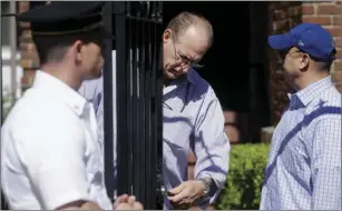  ?? AP PHOTO/JEFF CHIU ?? A man checks the front gate to the residence of the Russian consul in San Francisco on Monday.