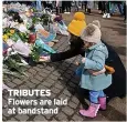  ??  ?? TRIBUTES Flowers are laid at bandstand