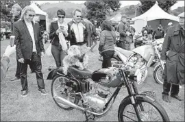  ?? Steve Burton ?? MOTORCYCLE fans get together at the Quail show last May. Ginger Damon, who sells women’s motorcycle clothing, says the show is both business and pleasure.