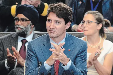  ?? SEAN KILPATRICK THE CANADIAN PRESS ?? Prime Minister Justin Trudeau, middle, Defence Minister Harjit Sajjan, left, and Minister of Foreign Affairs Chrystia Freeland.