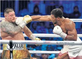  ?? /AFP ?? Title fight: British boxer Anthony Joshua., right, defeated Mexican-American boxer Andy Ruiz Jr during the heavyweigh­t boxing fight for the IBF, WBA, WBO and IBO titles.
