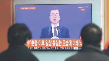  ??  ?? People watch a television screen broadcasti­ng live footage of Moon’s New Year’s speech, at a railway station in Seoul. — AFP photo