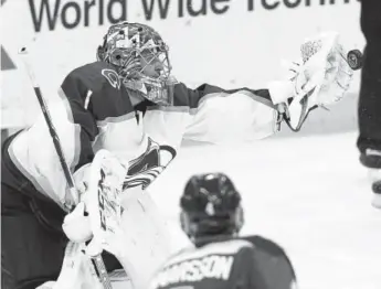  ?? Billy Hurst, The Associated Press ?? Avalanche goaltender Semyon Varlamov makes a glove save on a third- period shot by the Blues during Thursday night’s game in St. Louis. Varlamov contribute­d 44 saves to the Avs’ 4- 1 victory.