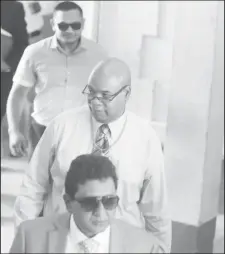  ??  ?? PPP/C Members of Parliament Anil Nandlall (in foreground), Juan Edghill (at centre) and Vickram Bharrat leaving the Georgetown Magistrate’s Courts yesterday.