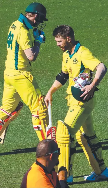  ?? Picture: PATRICK HAMILTON/AFP ?? Steve Smith (left) crosses paths with David Warner after the former Australian captain was dismissed during a one-day cricket practice against New Zealand in Brisbane