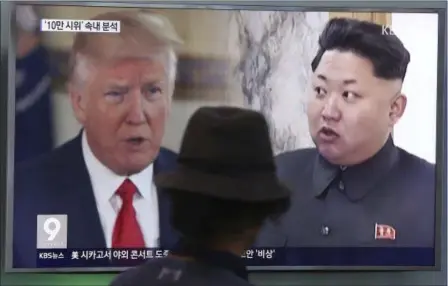  ?? AHN YOUNG-JOON — THE ASSOCIATED PRESS ?? A man watches a television screen showing President Donald Trump and North Korean leader Kim Jong Un during a news program at the Seoul Train Station in Seoul, South Korea, Thursday. President Donald Trump issued a new threat to North Korea on...