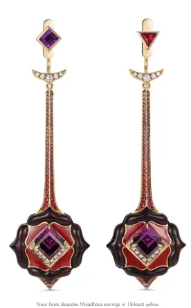  ??  ?? Noor Fares Bespoke Muladhara earrings in 18-karat yellow gold with carved rosewood, Amaranth garnets, amethyst, rubies, and diamonds, as well as pink, lavender, and yellow sapphires, and black rhodium and enamel