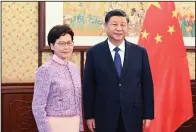  ?? (AP/Xinhua/Li Xueren) ?? Chinese President Xi Jinping at right poses for a photo with Chief Executive of the Hong Kong Special Administra­tive Region Carrie Lam Wednesday during a meeting in Beijing. Video online at arkansason­line.com/1223xi/.