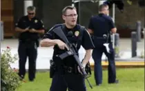  ?? GERALD HERBERT, THE ASSOCIATED PRESS ?? Police guard the emergency room entrance of Our Lady Of The Lake Medical Center, where wounded officers were brought in Baton Rouge.