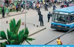  ??  ?? DOUALA: Cameroon police forces patrol at a traffic intersecti­on in Douala. — AFP