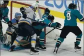  ?? JEFF CHIU — THE ASSOCIATED PRESS ?? Sharks center Logan Couture, middle right, celebrates with left wing Evander Kane after scoring against the Blues during the third period Monday.