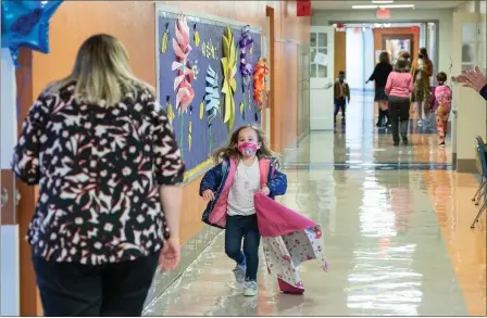  ?? PHOTO COURTESY OF EMILY OVERDORF ?? The excitement of being back in school is evident on this Lincoln Elementary School student’s face as she greets her teacher in person on Monday.