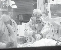  ?? TAMPA BAY TIMES ?? Medical workers at Morton Plant Hospital in Clearwater work to stabilize a COVID-19 patient Aug. 25.