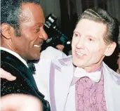  ?? G. PAUL BURNETT/AP ?? Chuck Berry, left, and Jerry Lee Lewis embrace at a reception in New York in 1986. A spokespers­on said Lewis died Friday at his home in Mississipp­i. He was 87.