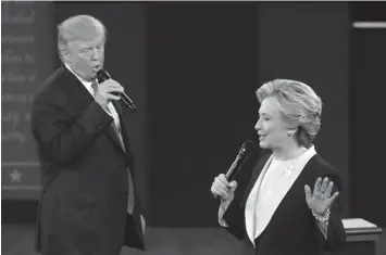  ?? ASSOCIATED PRESS ?? Republican presidenti­al nominee Donald Trump and Democratic presidenti­al nominee Hillary Clinton speak during the second presidenti­al debate at Washington University in St. Louis.