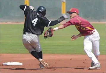  ?? Buy these photos at YumaSun.com PHOTOS BY RANDY HOEFT/YUMA SUN ?? ARIZONA WESTERN COLLEGE SHORTSTOP CARLOS ARELLENO (RIGHT) reaches out but can’t quite get the tag on ChandlerGi­lbert’s Tommy Cruz who steals second base in the top of the first inning of the first game of Tuesday afternoon’s doublehead­er at Kammann...