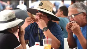  ?? RECORDER PHOTO BY CHIEKO HARA ?? The Carrera family — Frances, Cristian, and Fernando — enjoy delicious ribs together Saturday, Oct. 13 at Pioneer Day and Rib Cook-off event in downtown Portervill­e.