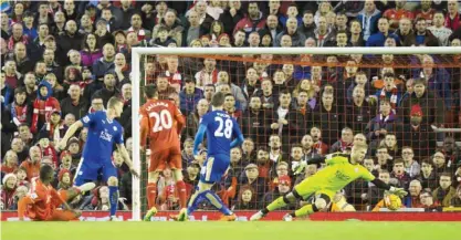  ??  ?? LIVERPOOL: Leicester City’s Kasper Schmeichel, right, is beaten as Liverpool’s Christian Benteke, bottom left, scores during the English Premier League soccer match between Liverpool and Leicester City at Anfield Stadium, Liverpool, England, yesterday....