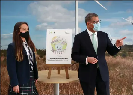  ??  ?? COP26 President Alok Sharma with Emma Khadeh, winner of an art competitio­n, at Whitelee Wind Farm, during his visit to Scotland