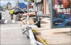  ?? NICHOLAS WILLIAMS / NEW YORK DAILY NEWS ?? A street pole is downed after a silver SUV crashed at the corner of 173rd St. and Hillside Ave. in Jamaica Hills on Saturday morning.