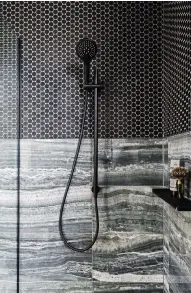  ??  ?? SHOWER ROOM
This main en suite boasts a moody theme with a palette of dark greys. Onyx Shadow large marble tiles; Nero Dime Mosaic small tiles; all price on request, Beaumont Tiles. Matt black Mizu Drift tapware, AU$400, Reece