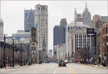  ?? Associated Press ?? Woodward Avenue is shown nearly empty in Detroit. Before the coronaviru­s showed up, downtown Detroit was returning to its roots as a vibrant city center, motoring away from its past as the model of urban ruin. Now, with the coronaviru­s forcing many office workers to their homes in the suburbs, those who remain wonder if revitaliza­tion will ever return.