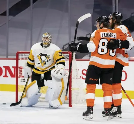  ?? AP ?? FLYING START: Joel Farabee and Kevin Hayes celebrate a goal during Philadelph­ia’s win over Pittsburgh last night in the first game of the 2021 season.