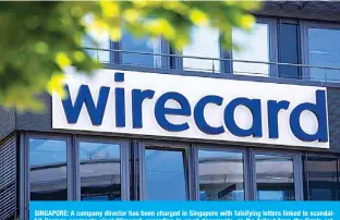  ??  ?? SINGAPORE: A company director has been charged in Singapore with falsifying letters linked to scandalhit German payments giant Wirecard, according to court documents, as the fallout from the firm’s collapse spreads further around the world.