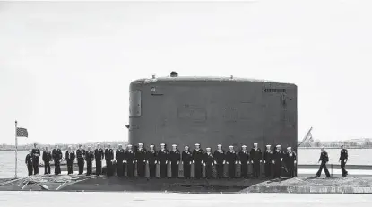  ?? Carolyn Kaster / Associated Press ?? Members of the Navy stand on the USS Delaware during a commission­ing ceremony Saturday at the Port of Wilmington in Delaware. With a crew of 136 sailors, the Delaware is the 18th Virginia-class fast attack submarine.