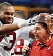  ?? AP ?? Alabama offensive lineman Evan Neal places the leather helmet from the “Old Leather Helmet Trophy” on head coach Nick Saban’s head after they defeated Miami in September. “We’re approachin­g this game with intentions to win,” he said of Saturday’s SEC Championsh­ip.